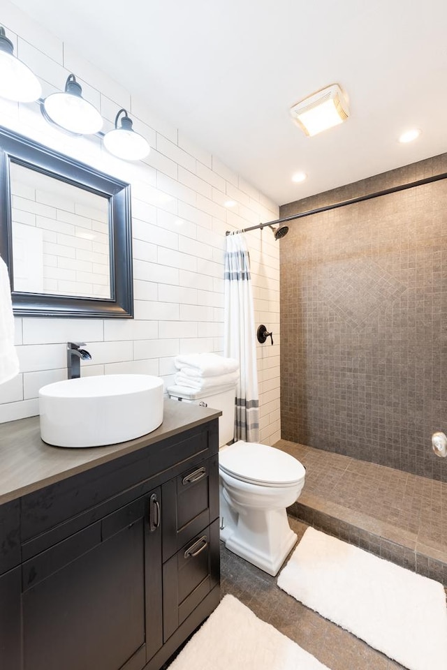 502 Deerpath St, Tolono, IL 61880 - full bath featuring a tile shower, vanity, toilet, and tile walls
