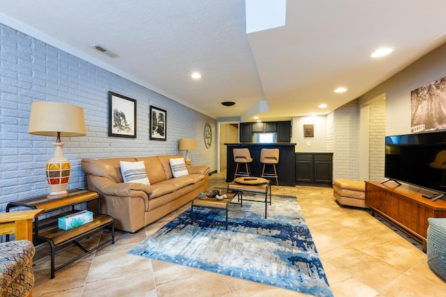 502 Deerpath St, Tolono, IL 61880 - living room with brick wall, recessed lighting, and light tile patterned floors