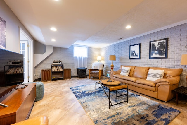 502 Deerpath St, Tolono, IL 61880 - living area featuring brick wall, a wood stove, tile patterned floors, and recessed lighting