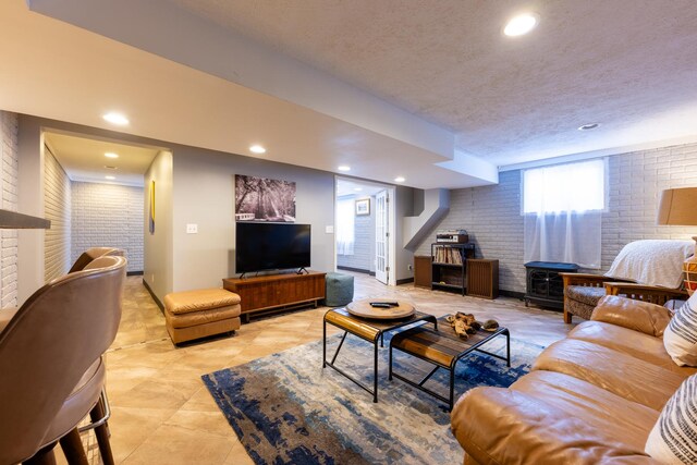 502 Deerpath St, Tolono, IL 61880 - living area with brick wall, a wood stove, recessed lighting, and a textured ceiling