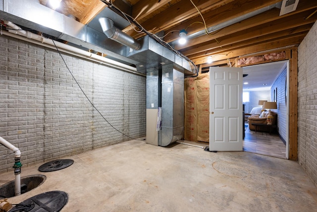 502 Deerpath St, Tolono, IL 61880 - below grade area with heating unit and brick wall