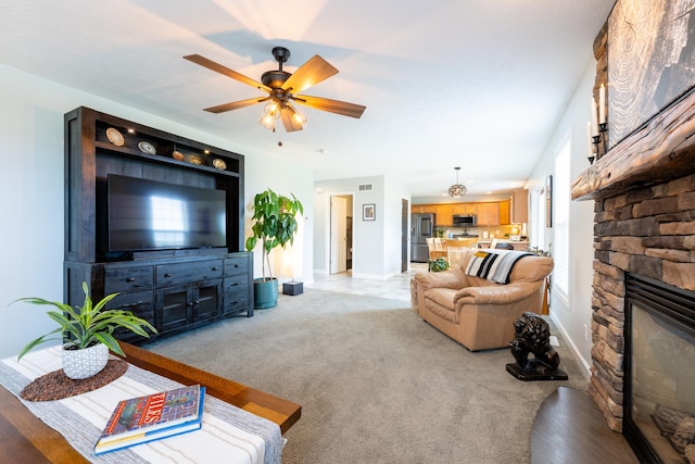 502 Deerpath St, Tolono, IL 61880 - living area featuring a ceiling fan, baseboards, a fireplace, and light colored carpet