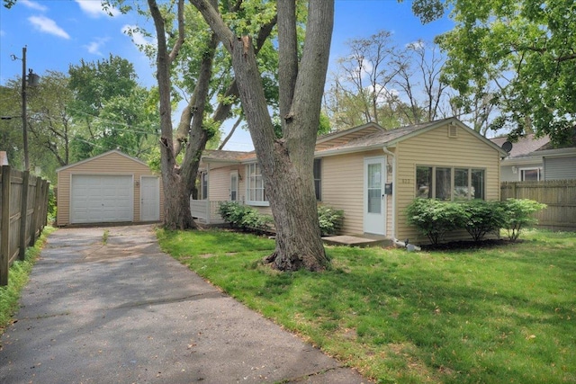 single story home with a garage and an outbuilding
