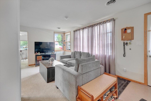 living room featuring light colored carpet and baseboards