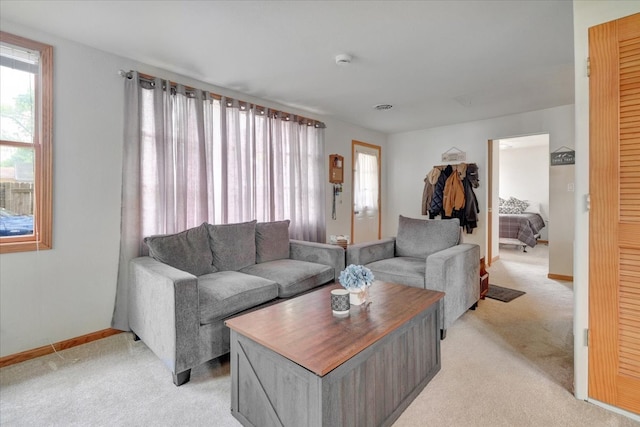 living room featuring light carpet and baseboards