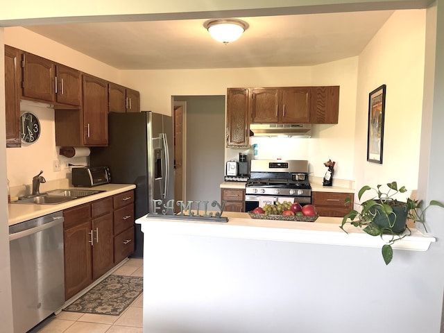 1510 Seville Ct Unit A1, Wheeling, IL 60090 - kitchen featuring stainless steel appliances, under cabinet range hood, light tile patterned floors, a peninsula, and light countertops