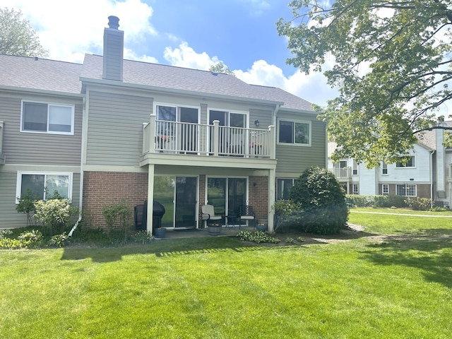 1510 Seville Ct Unit A1, Wheeling, IL 60090 - rear view of house with a balcony, a lawn, brick siding, and a chimney