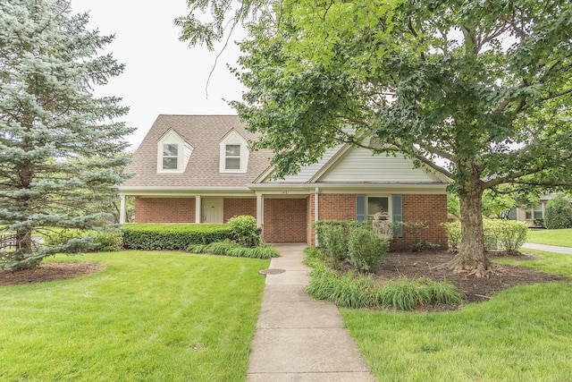 1510 Seville Ct Unit A1, Wheeling, IL 60090 - cape cod-style house featuring a front lawn and brick siding
