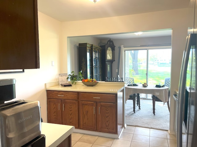1510 Seville Ct Unit A1, Wheeling, IL 60090 - kitchen featuring light countertops, stainless steel fridge with ice dispenser, light tile patterned floors, and brown cabinets