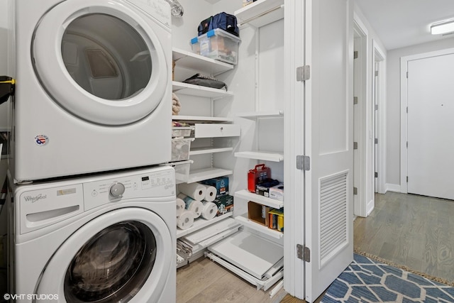 236 S Racine Ave Unit 304, Chicago, IL 60607 - laundry area featuring stacked washer and clothes dryer and wood finished floors