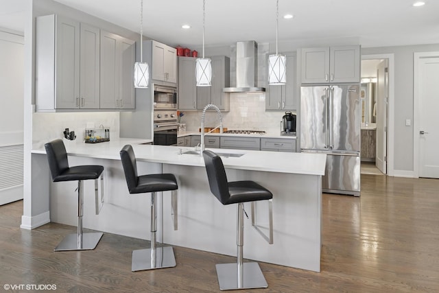 236 S Racine Ave Unit 304, Chicago, IL 60607 - kitchen with wall chimney exhaust hood, stainless steel appliances, a sink, a peninsula, and dark wood-type flooring