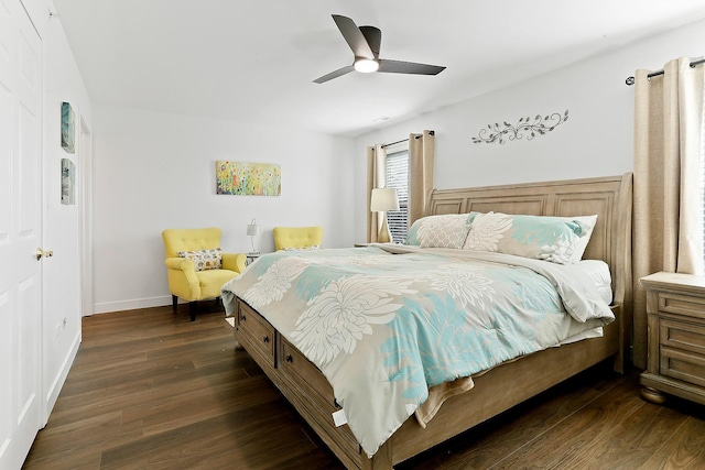 bedroom with dark wood-type flooring, a ceiling fan, and baseboards