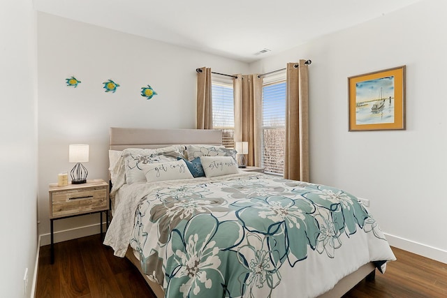 bedroom with baseboards and wood finished floors