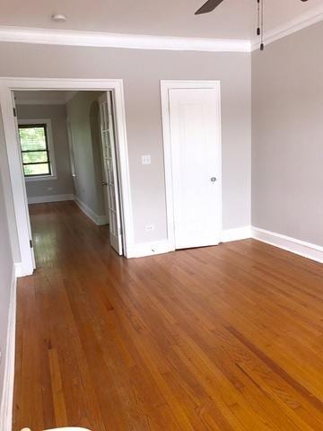 904 S Elmwood Ave Unit 3, Oak Park, IL 60304 - spare room featuring ornamental molding, baseboards, a ceiling fan, and wood finished floors