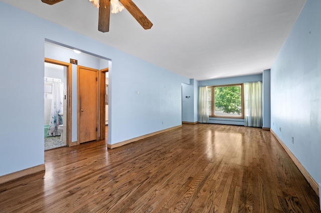 8941 S Albany Ave, Evergreen Park, IL 60805 - spare room with wood finished floors, a ceiling fan, and a baseboard heating unit