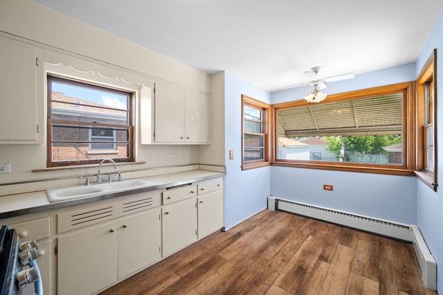 8941 S Albany Ave, Evergreen Park, IL 60805 - kitchen with a baseboard heating unit, white cabinetry, light countertops, and stainless steel range oven