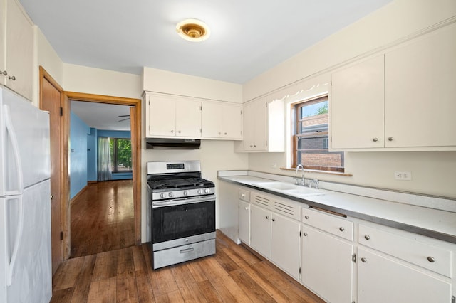 8941 S Albany Ave, Evergreen Park, IL 60805 - kitchen featuring gas stove, freestanding refrigerator, under cabinet range hood, and light wood-style flooring