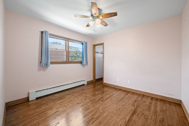 8941 S Albany Ave, Evergreen Park, IL 60805 - unfurnished room with baseboard heating, wood finished floors, and a ceiling fan