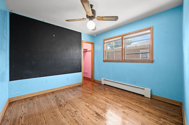 8941 S Albany Ave, Evergreen Park, IL 60805 - unfurnished room with baseboard heating, wood finished floors, and a ceiling fan