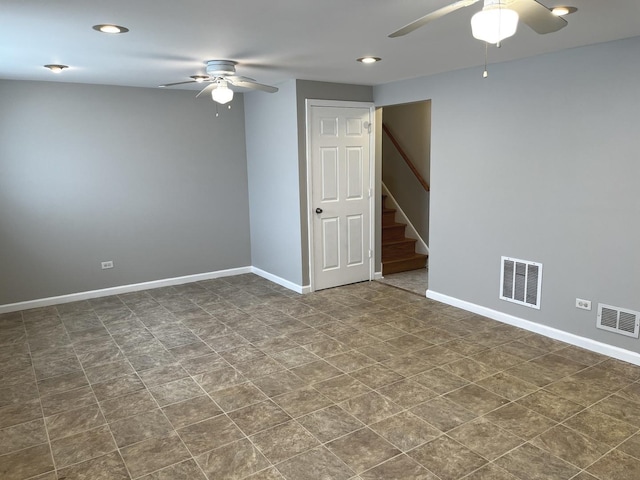 empty room featuring a ceiling fan, baseboards, stairs, and recessed lighting