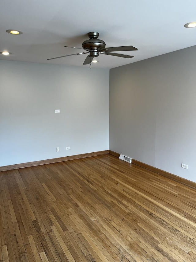 spare room with wood-type flooring, a ceiling fan, baseboards, and recessed lighting