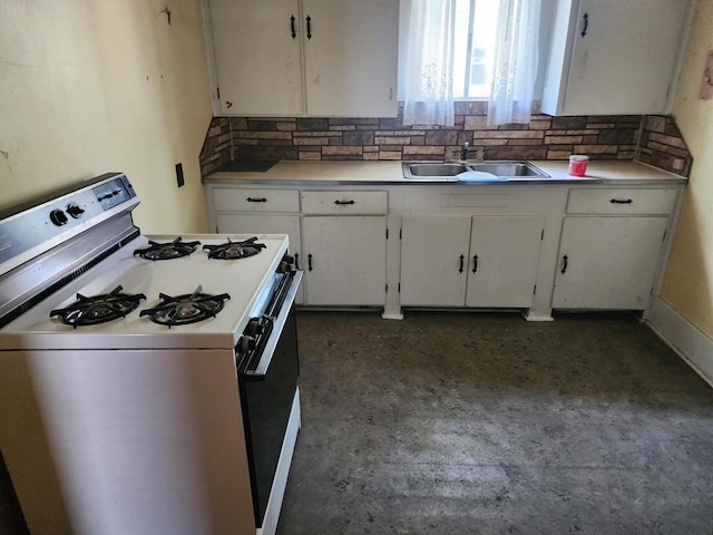 931 S Nelson Ave, Kankakee, IL 60901 - kitchen featuring white range with gas stovetop, a sink, white cabinets, and backsplash