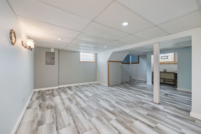 basement featuring stairway, light wood-style flooring, baseboards, a paneled ceiling, and recessed lighting