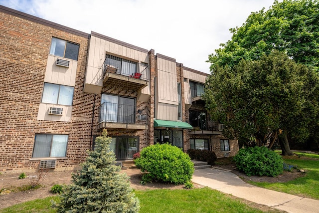 1477 Winslowe Dr Unit 302, Palatine, IL 60074 - view of building exterior featuring a wall mounted air conditioner