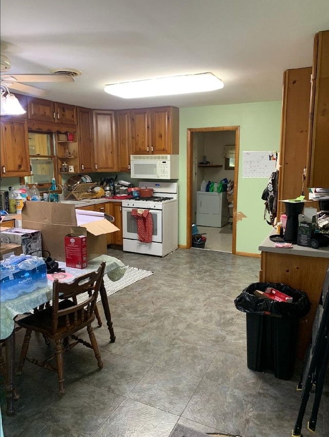 408 E Kyle St, Ogden, IL 61859 - kitchen with white appliances, brown cabinetry, ceiling fan, independent washer and dryer, and open shelves