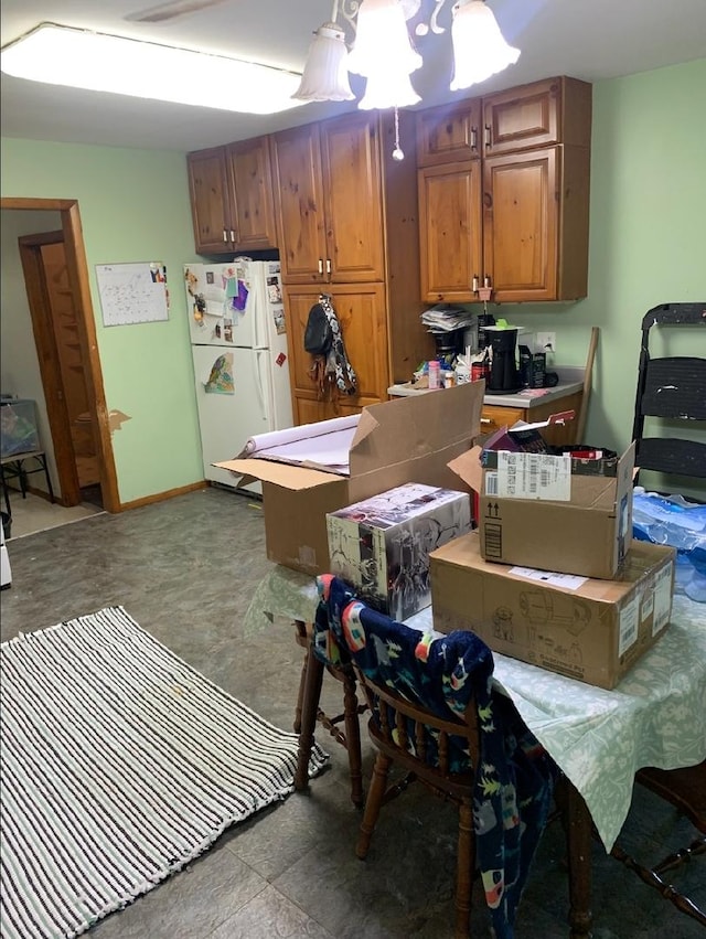 408 E Kyle St, Ogden, IL 61859 - kitchen with freestanding refrigerator, brown cabinets, concrete floors, and light countertops