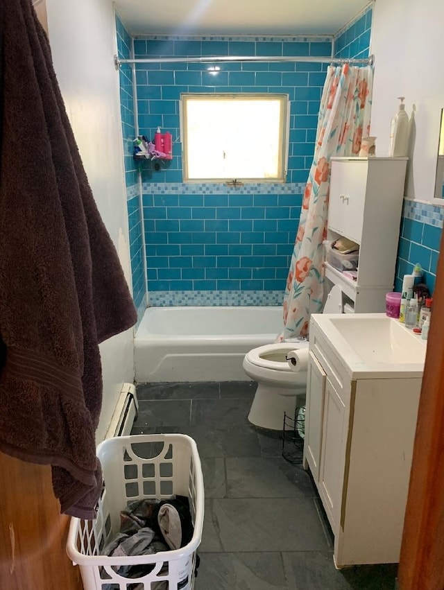 408 E Kyle St, Ogden, IL 61859 - full bathroom with baseboard heating, toilet, shower / tub combo, tile walls, and a sink