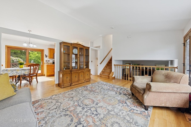3 Starwood Ct, Bolingbrook, IL 60490 - living room featuring a chandelier, light wood-style floors, lofted ceiling, and stairway