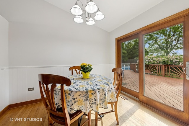 3 Starwood Ct, Bolingbrook, IL 60490 - dining space featuring light wood finished floors, a chandelier, lofted ceiling, a wainscoted wall, and baseboards