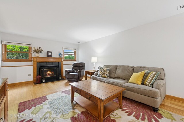 3 Starwood Ct, Bolingbrook, IL 60490 - living room with wood finished floors, a tiled fireplace, and baseboards