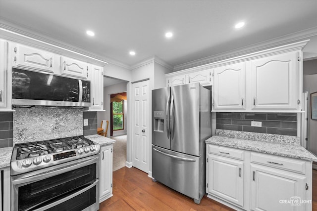 1070 Hobble Bush Ln, Elgin, IL 60120 - kitchen with appliances with stainless steel finishes, crown molding, wood finished floors, backsplash, and white cabinets