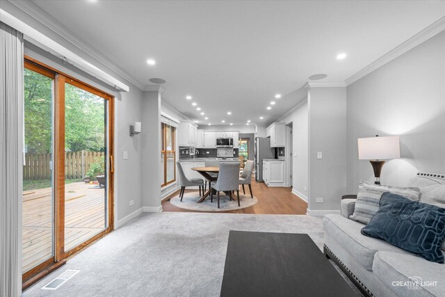 1070 Hobble Bush Ln, Elgin, IL 60120 - living room featuring crown molding, recessed lighting, baseboards, and light wood finished floors