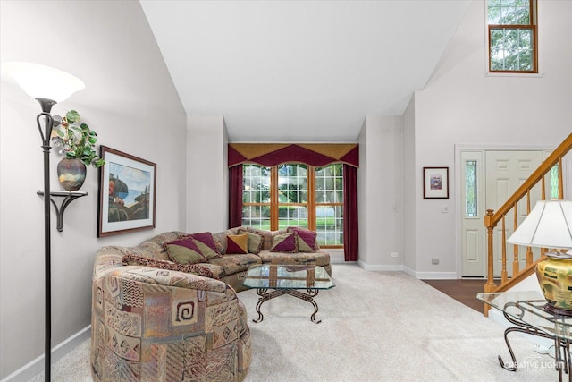 1070 Hobble Bush Ln, Elgin, IL 60120 - living room with stairway, high vaulted ceiling, carpet flooring, healthy amount of natural light, and baseboards