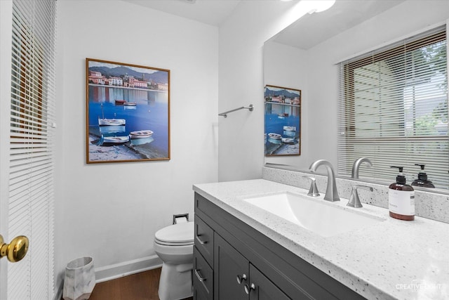 1070 Hobble Bush Ln, Elgin, IL 60120 - half bath featuring vanity, toilet, wood finished floors, and baseboards