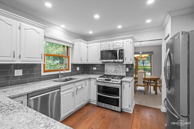 1070 Hobble Bush Ln, Elgin, IL 60120 - kitchen with appliances with stainless steel finishes, a sink, crown molding, white cabinets, and dark wood finished floors