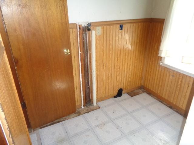 308 Genoa St, Cherry Valley, IL 61016 - empty room featuring wooden walls, light floors, and wainscoting
