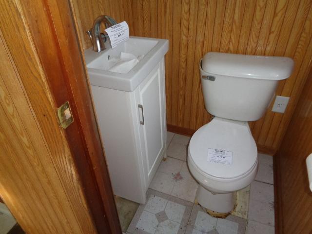 308 Genoa St, Cherry Valley, IL 61016 - bathroom with vanity, toilet, and wood walls