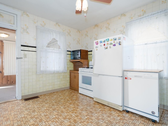 4949 W Deming Pl, Chicago, IL 60639 - kitchen with white appliances, a ceiling fan, wallpapered walls, and light flooring