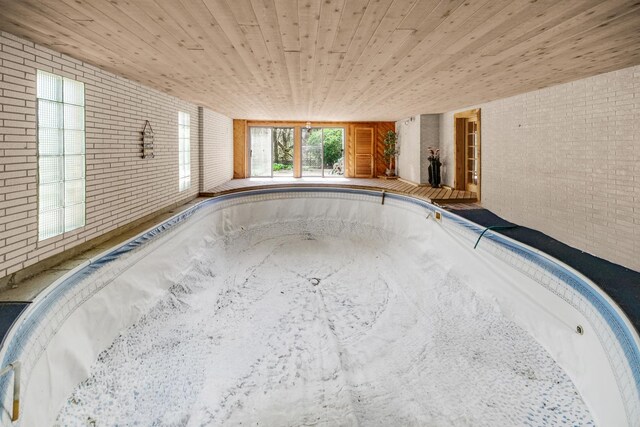 32381 N Forest Dr, Grayslake, IL 60030 - detailed view of brick wall, a jacuzzi, and wooden ceiling