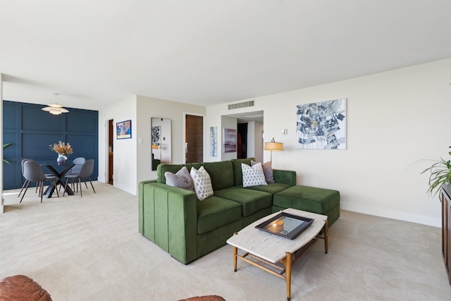 living room featuring light colored carpet and baseboards