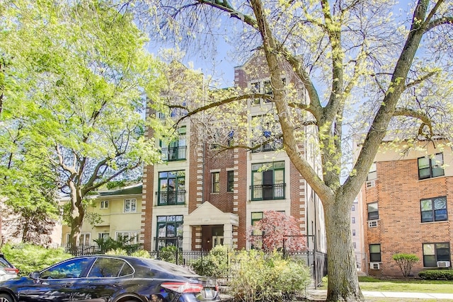 townhome / multi-family property featuring brick siding