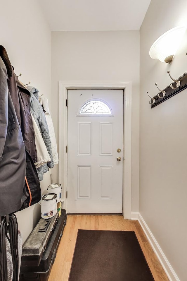 doorway to outside featuring light wood-type flooring and baseboards