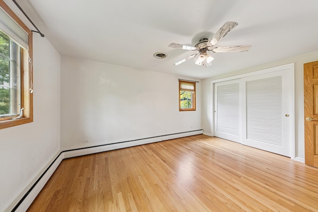 6 Old Timber Ln, Palos Park, IL 60464 - unfurnished bedroom featuring multiple windows, light wood-style flooring, a closet, and baseboard heating