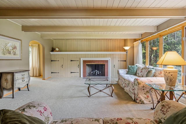 6 Old Timber Ln, Palos Park, IL 60464 - carpeted living room with arched walkways, beam ceiling, a brick fireplace, and wood ceiling