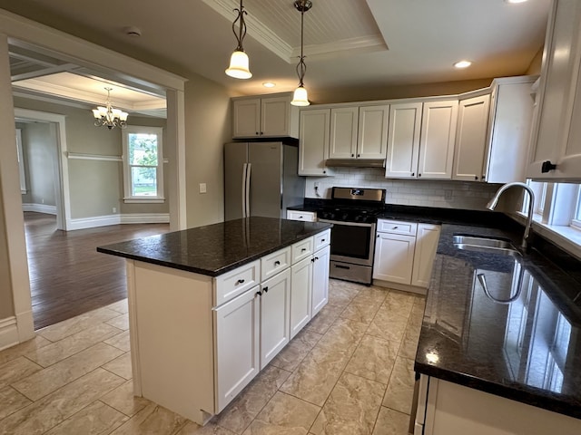 1527 7th St, Peru, IL 61354 - kitchen with a tray ceiling, stainless steel appliances, a sink, ornamental molding, and decorative backsplash