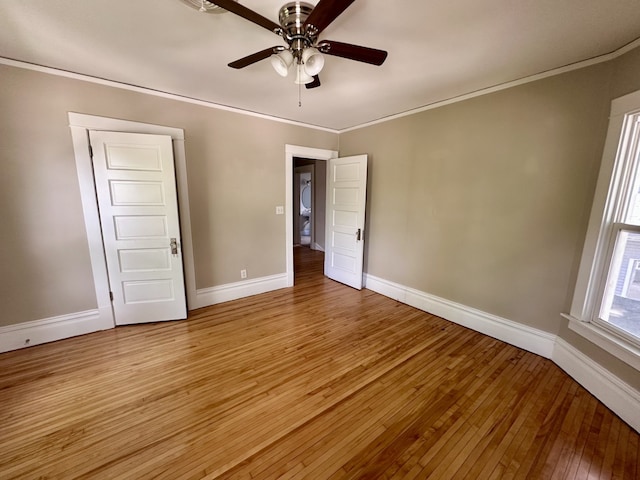 1527 7th St, Peru, IL 61354 - unfurnished bedroom featuring baseboards, light wood finished floors, ornamental molding, and a ceiling fan
